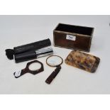 A silver coloured metal mounted burr wood box, 16 cm wide, a tortoiseshell magnifying glass, and