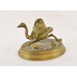 A late 19th/early 20th century brass inkwell, in the form of a running ostrich, with pen stand on an