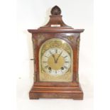 A Victorian walnut mantel clock, the arched brass dial with Roman numerals, signed W Campbell 36 &