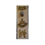 Twenty seven assorted cap, collar and shoulder badges, including T R E East Anglian shoulder badge