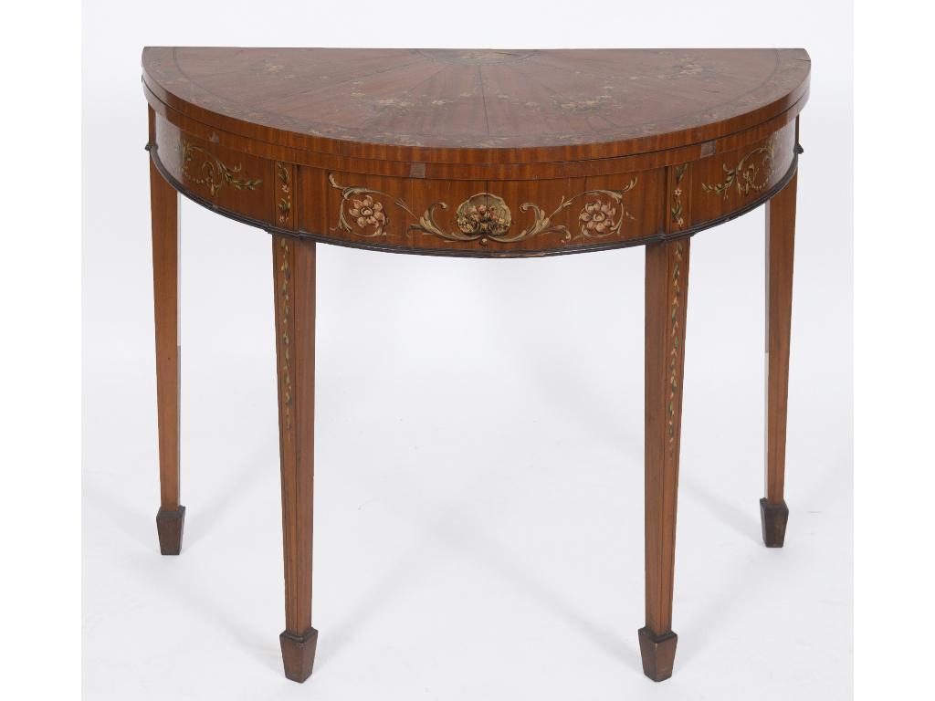 A late Victorian D shape card table, veneered in satinwood and with painted floral decoration, on