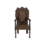 A carved oak wainscot armchair See illustration