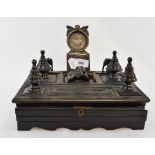 An 19th century ebony desk stand, with pocket watch holder, some losses and damage, 27 cm wide