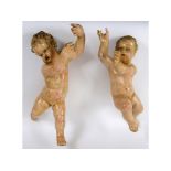 A pair of Continental painted and gilded hanging putto, approx. 60 and 65 cm high (2) See