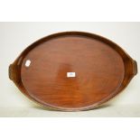 A 19th century oval mahogany tray, bound in brass, 57 cm wide