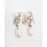 A pair of drop earrings, in the form of flowerheads, set simulated pearls and white stones Report by