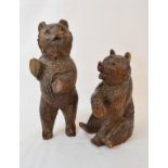 A Black Forest carved wood bear, seated, some chips, 17 cm high, and another similar (2)