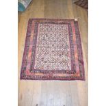 An Eastern rug, decorated geometric motifs on a beige ground, within a multi border, 170 x 134 cm,