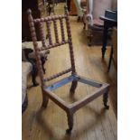 A fruitwood low chair, having a bobbin turned back Just a frame. Lacking rear casters. Frame