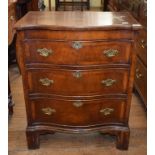 An early 18th century style serpentine front chest, veneered in walnut, having three graduated
