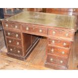 A mahogany pedestal desk, the leather inset top above an arrangement of nine drawers, with a pair of