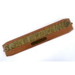 A ship's lifeboat nameplate, S.S. Britannic, drilled and mounted on a wooden plaque, with a