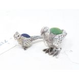 A novelty silver pincushion, in the form of a pheasant, 3.5 cm high, and another (2) Report by NG