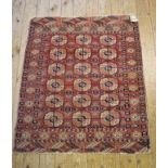 An Eastern rug, decorated lozenges on a red ground, within a multi border, 118 x 97 cm, and
