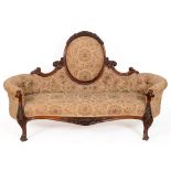 A Victorian walnut button back three seater settee, with carved floral decoration and See