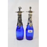 A pair of blue glass decanters, with plated grape and vine mounts, 29 cm high (2)