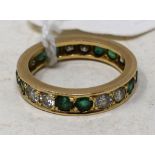 A diamond and green stone eternity ring, approx. ring size M Report Approx. 3.7 g (all in) Report by