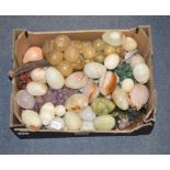 A quantity of polished hard stone eggs, similar fruit, and assorted shells (box)
