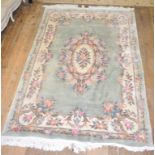 A Chinese rug, decorated flowers and foliage on a light coloured ground, 282 x 182 cm and other