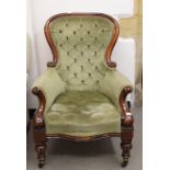 A Victorian mahogany button back upholstered armchair, on turned and fluted front legs