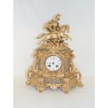 A matched clock garniture, the mantel clock applied a horse and rider, 40.5 cm high (3)