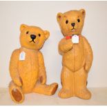 A doorstop in the form of a seated teddy, 36.5 cm high, another similar, standing, 44.5 cm high, a