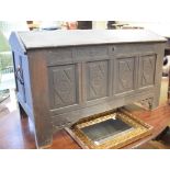 A 19th century oak coffer, the shaped top above a carved four panel front, 124 cm wide