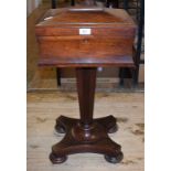 An early Victorian rosewood teapoy, on a tapering octagonal column and concave sided platform
