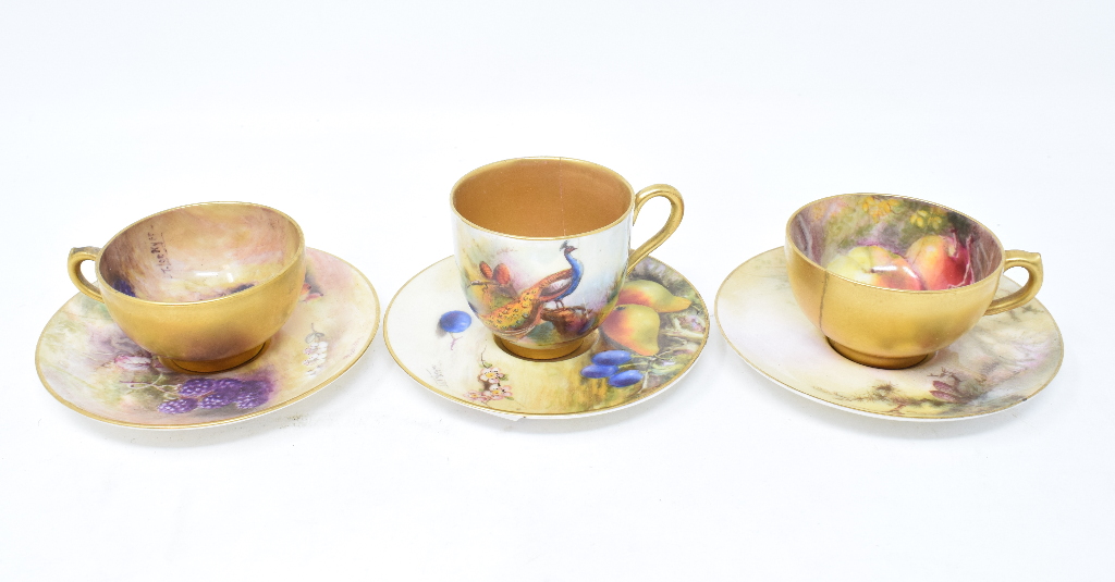 A Royal Worcester porcelain cup and saucer, painted fruit, the cup signed T Lockyer, saucer signed