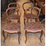 A set of four Victorian carved walnut balloon back dining chairs, on cabriole front legs (4)