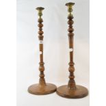 A pair of large treen candlesticks, with brass sconces, 57 cm high (2)