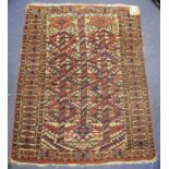 An Eastern rug, decorated geometric motifs on a beige ground, within a multi border, 108 x 80 cm