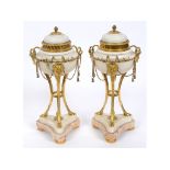 A pair of 19th century French white marble and ormolu cassolettes, decorated swags and tassels, on