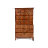 A tallboy chest on chest, veneered in walnut, having two short and three graduated long drawers,
