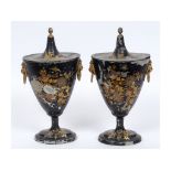 A pair of 19th century toleware chestnut vases and covers, with lion mask ring handles, and