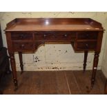 A Victorian mahogany table, having a three quarter gallery above an arrangement of five drawers,