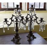 A pair of metal three light candelabra, with prismatic drops, 53 cm high (2) Report by GH Probably