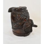 A black forest style carved wood tobacco jar, in the form of a smoking dog, with glass eyes, 18 cm