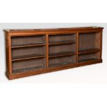 A large late Victorian walnut open bookcase, on a plinth base, 306 cm wide See illustration Report