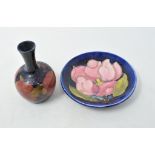 A Moorcroft Pottery Pomegranate vase, 9 cm high, a similar Magnolia pin dish, a silver goblet, a