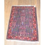 An Eastern rug, decorated stylised foliage on a dark blue ground, within a multi border, 145 x 102