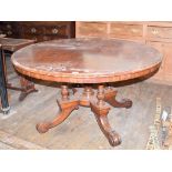 A Victorian mahogany centre table, the tilt top on four fluted and carved columns with four
