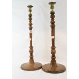 A pair of large treen candlesticks, with brass sconces, 57 cm high (2)