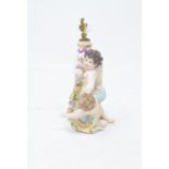 A Continental porcelain scent bottle, in the form of two putti with a flower garland, with gilt