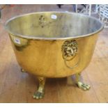 A brass log bin, with lion mask handles and paw feet, 44 cm diameter