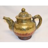 A Tibetan copper and brass teapot with embossed decoration, 26 cm high