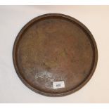 An Islamic brass tray, decorated calligraphy, 29 cm diameter, and two others similar, 14.5 and 11 cm