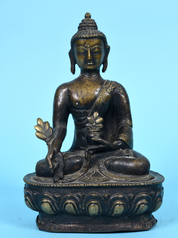 A Nepalese bronze Buddha, seated, on a lotus leaf base, 21 cm high See inside front cover