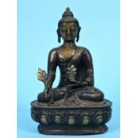 A Nepalese bronze Buddha, seated, on a lotus leaf base, 21 cm high See inside front cover