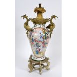 A Chinese famille rose vase, of baluster form, decorated figures and foliage, with gilt metal mounts